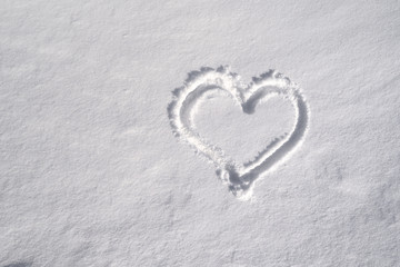 Symbol of heart, painted on the fresh white snow