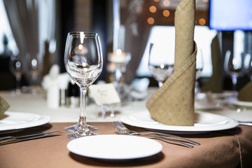 catering at a top event, glasses and flowers on the table, preparation for a significant event, beautiful dishes and glasses on the table, New Year's holiday table