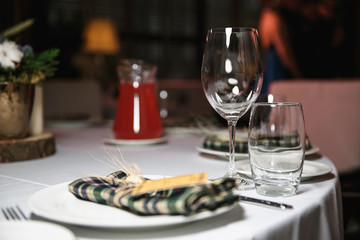 catering at a top event, glasses and flowers on the table, preparation for a significant event, beautiful dishes and glasses on the table, New Year's holiday table