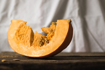 Fresh pumpkin on the table from old boards. Horizontal orientation and white background.