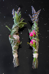 Sage, rose and lavender smudge sticks on black background