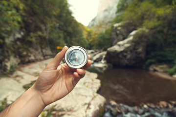 man hand compass in forest background