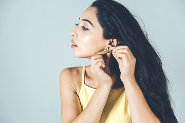 Obraz premium young woman hand earring in ear