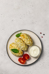 Healthy vegetable steamed rissoles with sour cream sauce.Top view, space for text.