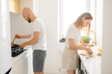 husband and wife cooking in the kitchen