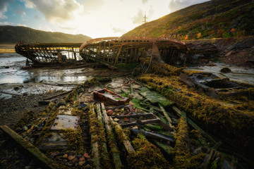 Naklejka na ściany i meble Abandoned ships cemetery at low tide near Teriberka village in Murmansk Region. Kola peninsula, Northern Russia