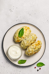 Healthy vegetable steamed rissoles with sour cream sauce.Top view, space for text.