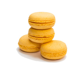 four yellow macaroons on a white background isolated