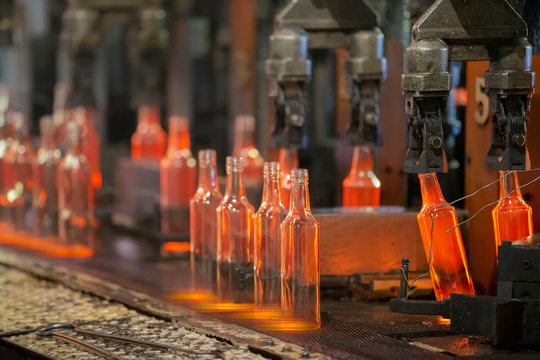 Glassworks. Glass industry. The process of making glass bottles.