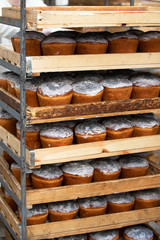 Upright wooden pallets with baked easter. Industrial production of Easter cakes. Bakery.