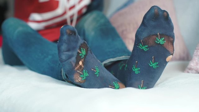 Homeless man scratches his leg