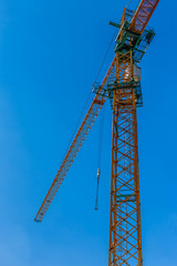 Fototapeta na wymiar Construction site background. Hoisting cranes and new multi-storey buildings. I.ndustrial background.Building construction site work against blue sky