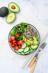 Healthy food. budha bowl with quinoa, avocado, cucumber, salad, tomatoe, olive oil. Clean eating, diet food. Bright background.