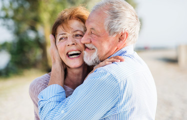 Close-up of senior couple on a holiday on a walk, hugging.