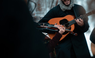 Fototapeta na wymiar street musicians playing guitar and violin