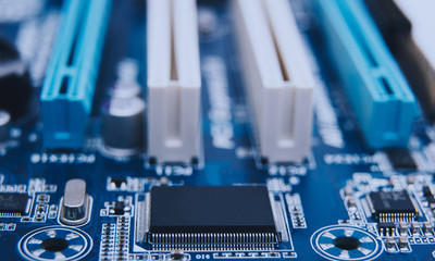 Electronic chip. Close up photo of blue PC circuit board.