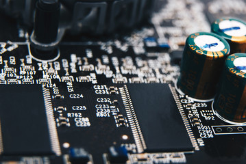Electronic chip. Close up photo of black PC circuit board.