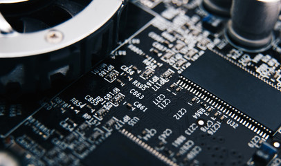 Electronic chip. Close up photo of black PC circuit board.