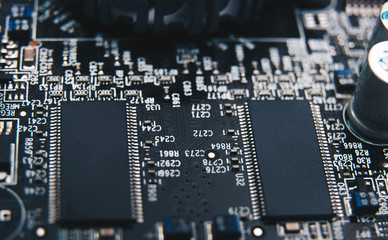 Electronic chip. Close up photo of black PC circuit board.