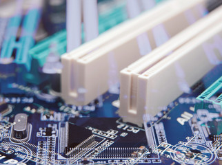 Electronic chip. Close up photo of blue PC circuit board. Abstract background.