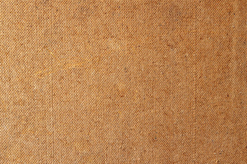 Hardboard backside background image. Background paintings from fiberboard. Fibrous leaf leaf back side texture. A closeup shot of a fiber surface texture. Fiberboard back wallpaper.
