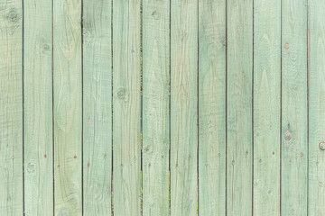 abstract background of painted in turquoise color wooden fence close up