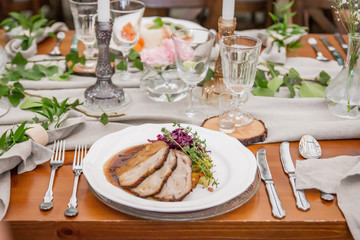  The second course is meat and salad. Hot dish. Rustic decoration from natural things for a perfect wedding reception. Boho party. Elegant catering.