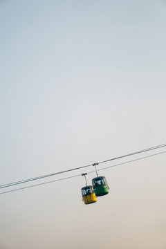 Tilt shift view of cable cars carrying passengers
