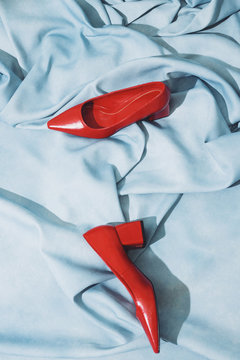 Red heel shoes placed on cloth