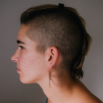 Profile of woman with shaved side hairstyle