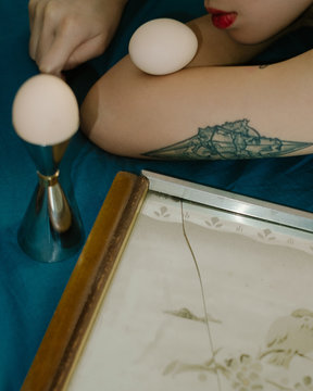 View of woman holding eggs on her elbow