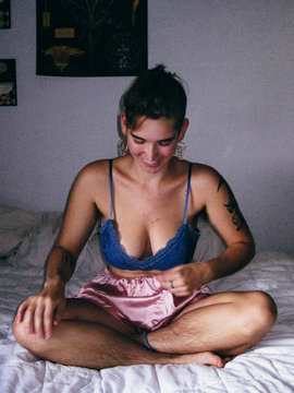 Portrait of woman sitting on bed