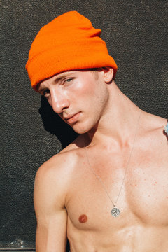 Close up view of young man in orange knitted cap