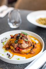Grilled Tuna Steak with Stewed Vegetables on White Plate.