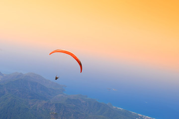Paragliding Extreme sport, Paraglider flying on the blue sky an sunset.