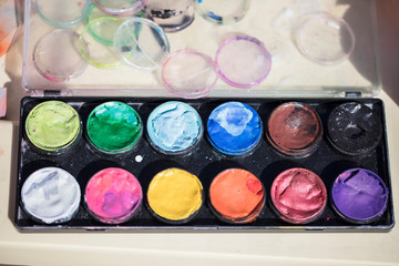 Multi-colored watercolor paints. A palette of different colors for face painting
