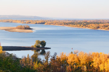 Golden autumn in Ukraine. View of the Dnieper, a small island and yellow trees in the city of...