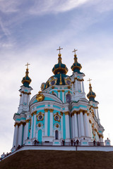 Fototapeta na wymiar Kiev, Ukraine, October 2019. St. Andrew's Orthodox Church on St. Andrew's Uzvoz in the Ukrainian capital, Kiev. Golden domes against the blue sky.