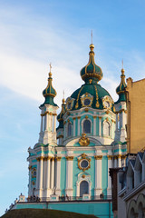 Fototapeta na wymiar Kiev, Ukraine, October 2019. St. Andrew's Orthodox Church on St. Andrew's Uzvoz in the Ukrainian capital, Kiev. Golden domes against the blue sky.