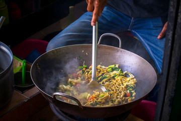 Delicious fried noodles at a busy street food market
