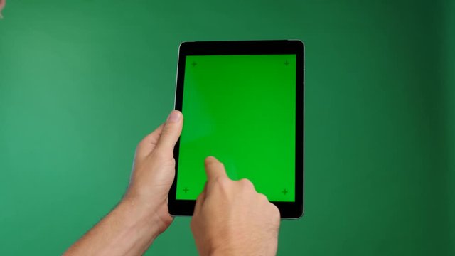 Person holding a touch screen tablet or a smart  pad and swiping the content to the right four times. Green screen isolated chroma key clip with motion track point marks