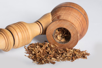 Close-up wooden pipe for smoking with tobacco on a white background