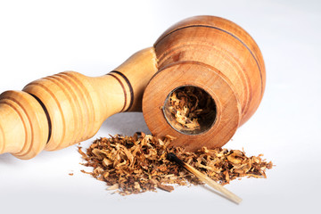 Close-up wooden smoking pipe with tobacco and burned matches on a white background