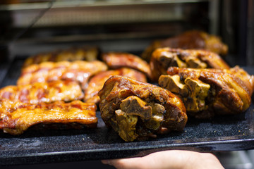 the cook takes out of the oven baked ruddy meat with a golden crispy crust