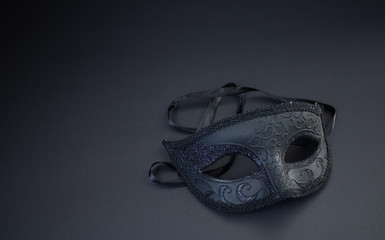 Vintage old black masquerade mask on the black background.Stylish and luxury background or...