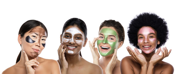Beautiful multi-ethnic group of girls with colorful peel-off masks on their faces