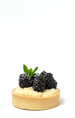 homemade Tart (tartlet) with blackberry and delicate cream of vanilla and mint
