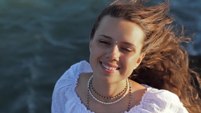 Portrait of a woman in the wind near the sea