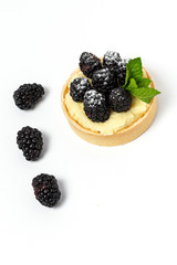 homemade Tart (tartlet) with blackberry and delicate cream of vanilla and mint