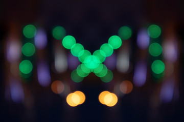 Multicolored bokeh patterns on a dark blue background.